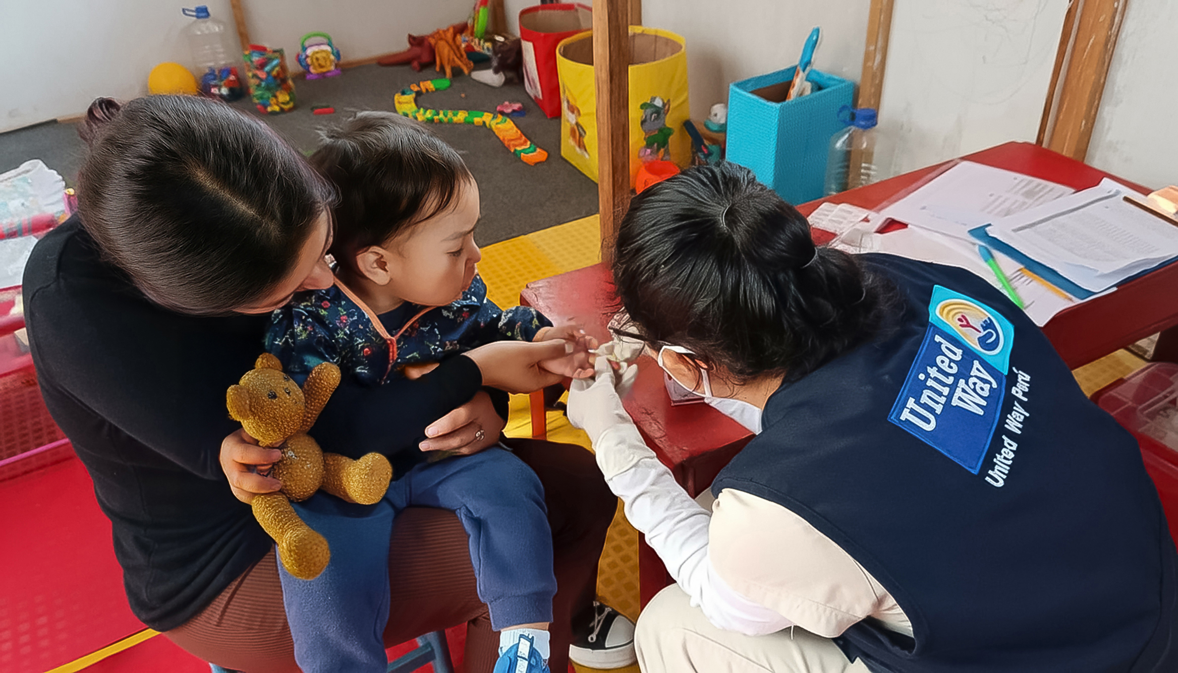 Two people hand food to eachother outside a car